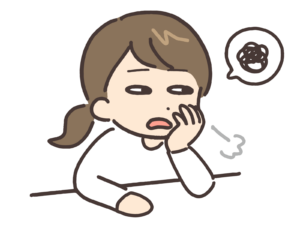 肘をついてため息をつく女性